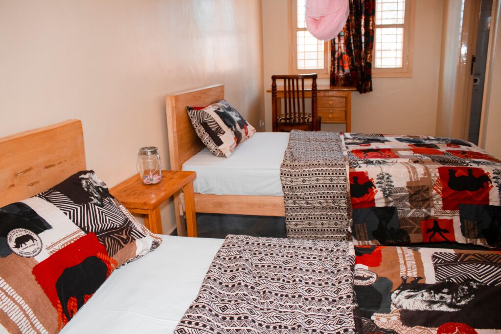 Cozy bedroom with two twin beds featuring colorful African-inspired bedding.